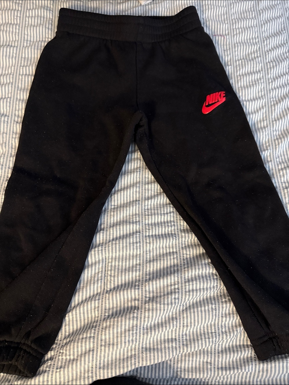 Nike Kids Black Sweatpants with Red Swoosh Logo